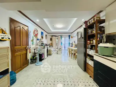 Spacious open-plan living and dining area with modern kitchen appliances and stylish decor.
