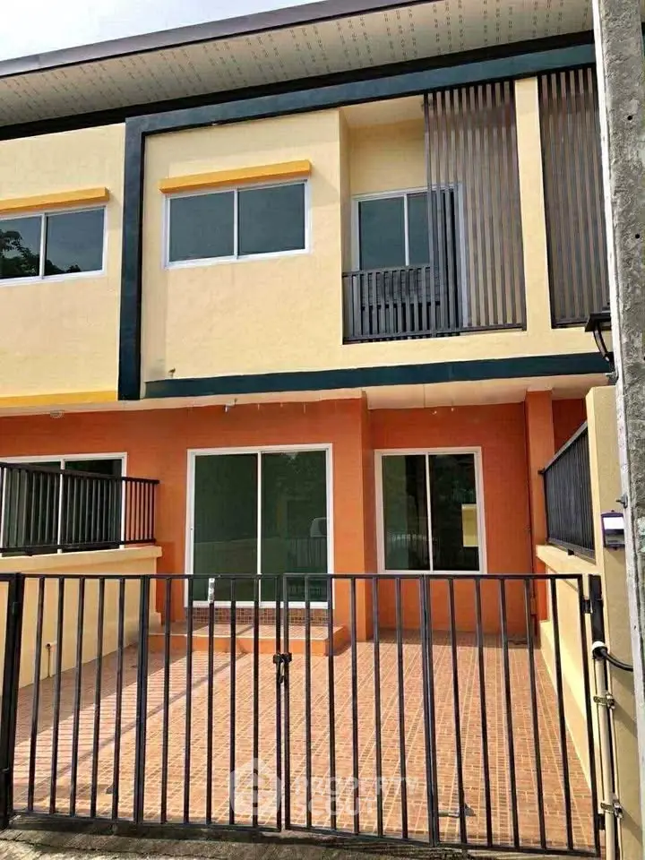 Modern two-story townhouse with gated entrance and spacious balcony