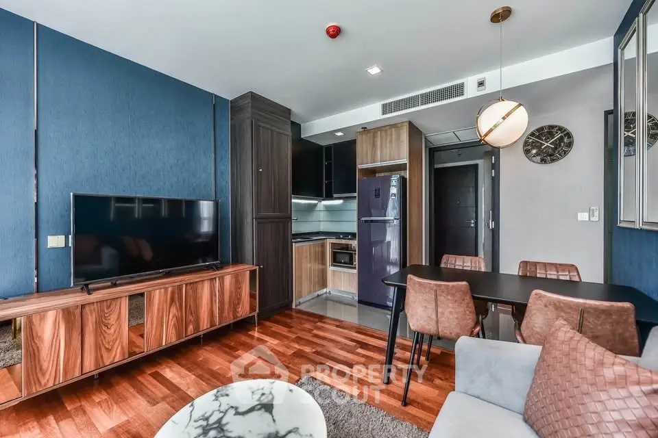 Modern living room with stylish furniture and open kitchen layout in a contemporary apartment.