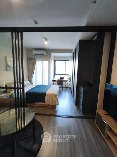 Modern studio apartment with open layout and stylish furnishings, featuring a cozy bedroom and living area.