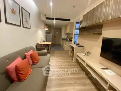 Modern living room with stylish decor and open kitchen layout in a cozy apartment.
