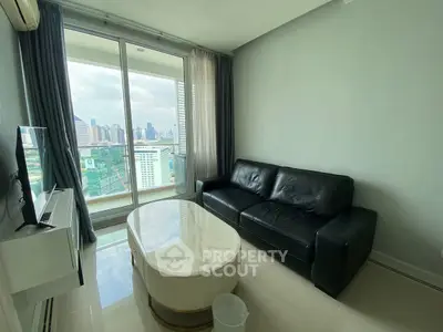 Modern living room with city view, featuring sleek black leather sofa and glass coffee table.
