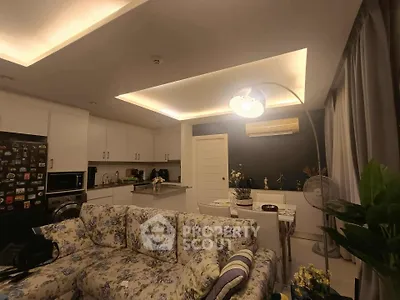 Cozy living room with floral sofa and modern kitchen in open layout