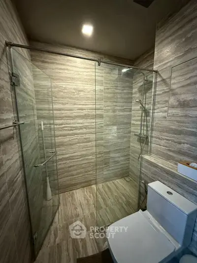 Modern bathroom with glass shower enclosure and sleek tile design