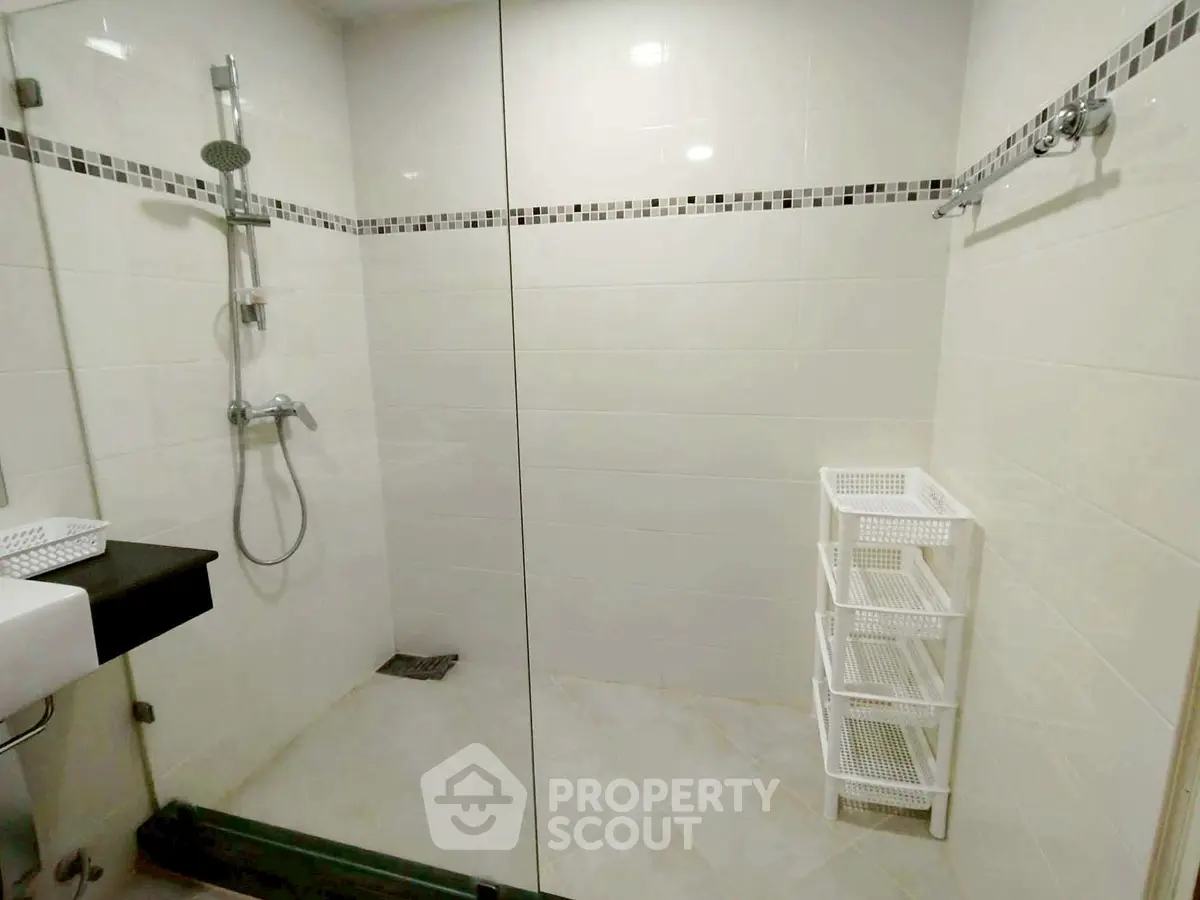 Modern bathroom with glass shower and sleek tile design