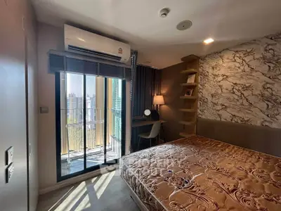 Modern bedroom with balcony view and stylish decor in urban apartment