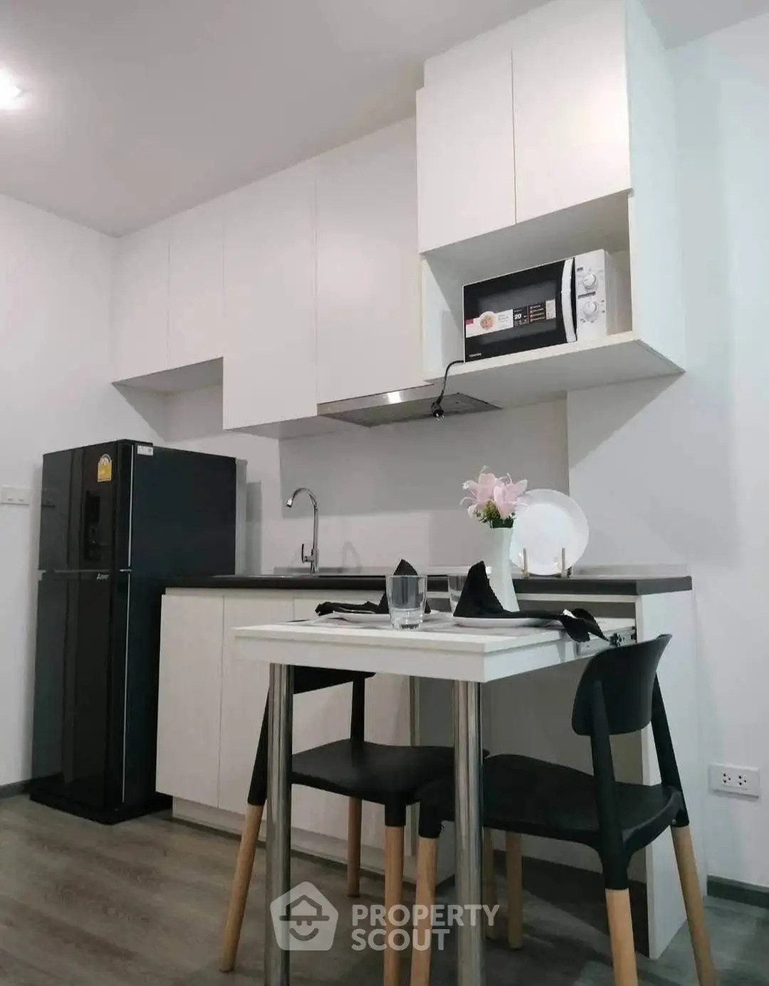 Modern kitchen with sleek cabinetry and dining area in a stylish apartment
