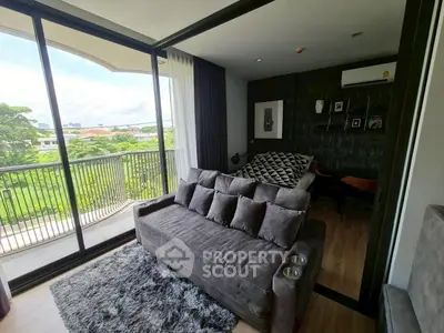 Modern living room with cozy sofa and balcony view in stylish apartment