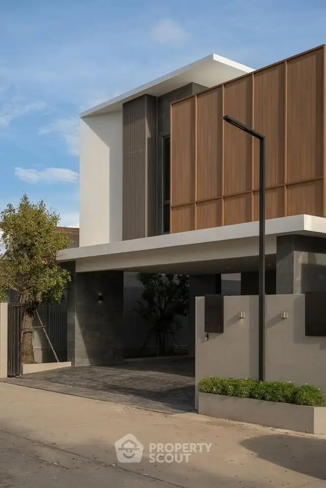 Modern architectural home exterior with sleek design and natural wood accents.