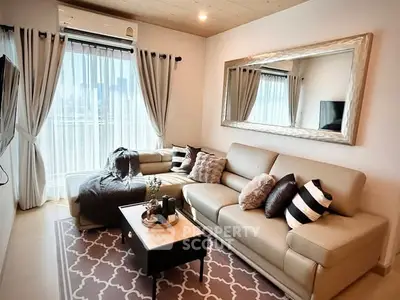 Stylish living room with large mirror and cozy seating in modern apartment