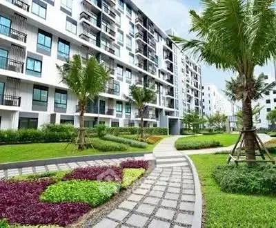 Modern apartment building with lush landscaped garden and pathway