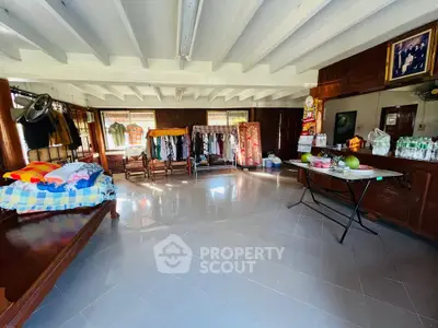 Spacious living area with traditional decor and ample natural light.