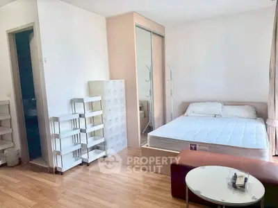 Modern studio apartment with wooden flooring and ample natural light