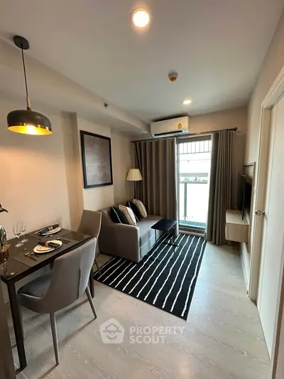 Modern living room with stylish decor, cozy seating, and dining area in a contemporary apartment.
