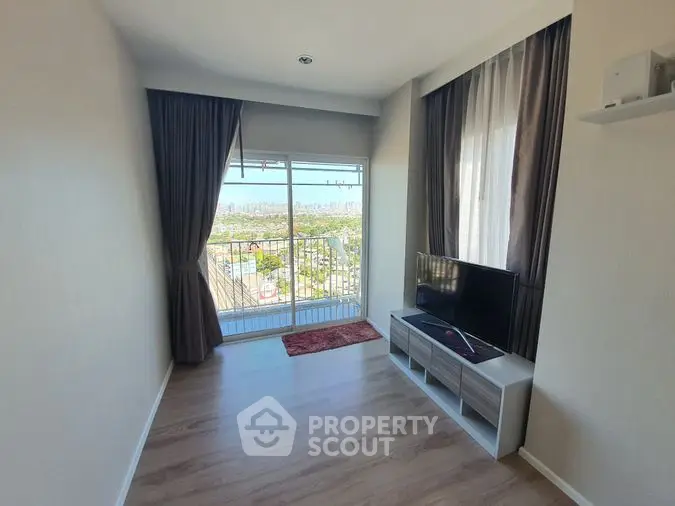 Bright and airy living room with expansive windows offering a panoramic city view, complemented by elegant drapery and modern flooring.