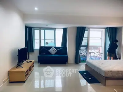 Spacious modern living area with balcony and stylish furnishings