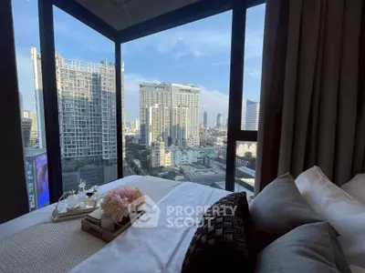 Luxurious bedroom with stunning city view from floor-to-ceiling windows, featuring elegant decor.