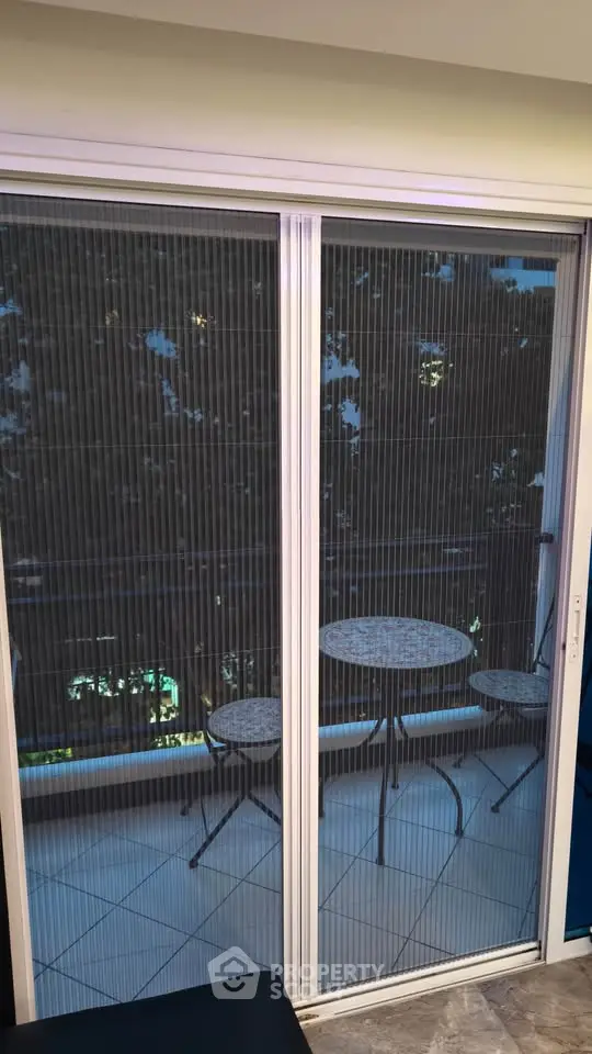 Charming balcony view with cozy outdoor seating, perfect for relaxation and enjoying the scenery.