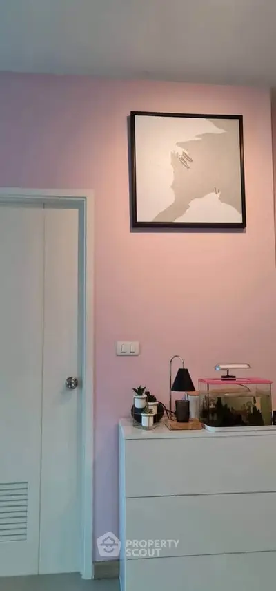 Chic modern bedroom with pink accent wall and stylish decor