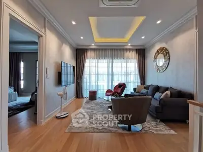 Luxurious living room with modern decor and large windows in a stylish apartment.