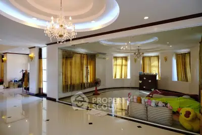 Spacious living room with elegant chandelier and large mirrors, perfect for luxury living.