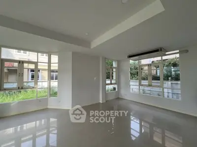 Spacious modern living room with large windows and natural light