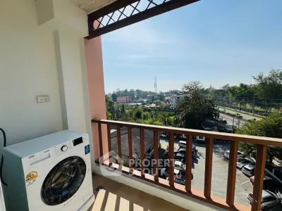 Charming balcony with scenic view and modern washing machine, perfect for urban living.