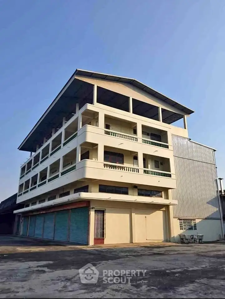Spacious multi-story commercial building with ample parking space and modern design.