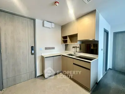 Modern kitchen with sleek cabinetry and integrated appliances in a contemporary apartment.
