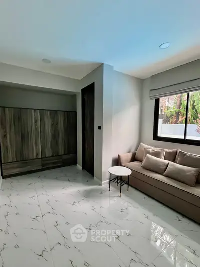 Modern living room with sleek sofa and marble flooring