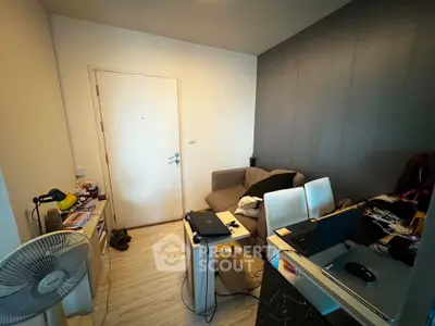Cozy living room with modern decor and workspace setup, ideal for urban living.