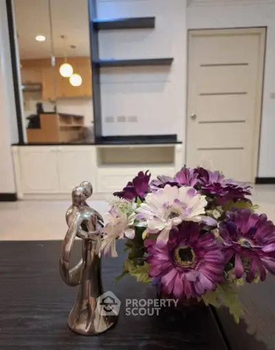 Elegant living room with modern decor and floral centerpiece