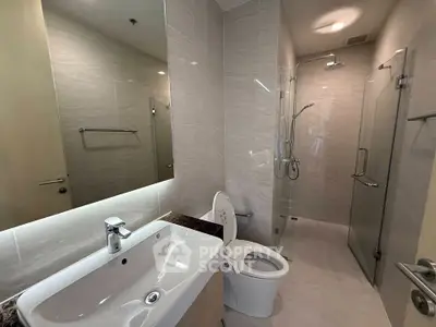 Modern bathroom with sleek fixtures and glass shower enclosure