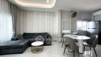 Modern living room with sleek furniture and open kitchen layout