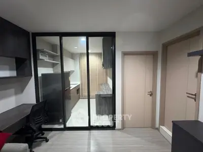 Modern apartment interior with glass partition and sleek kitchen design