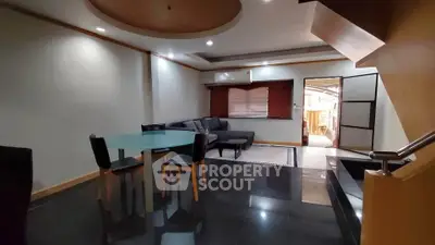 Spacious modern living room with sleek black flooring and stylish furniture