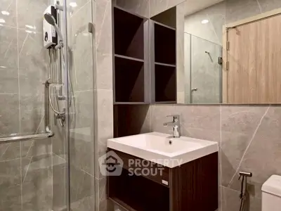 Modern bathroom with sleek fixtures and glass shower enclosure