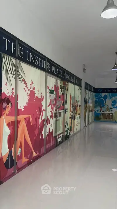Vibrant hallway with colorful wall art in modern building, showcasing creative and inspiring atmosphere.