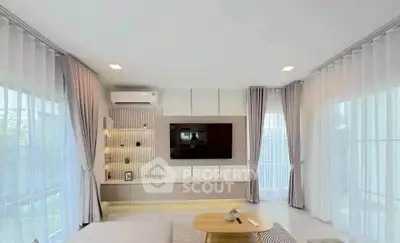Spacious modern living room with large windows and elegant decor