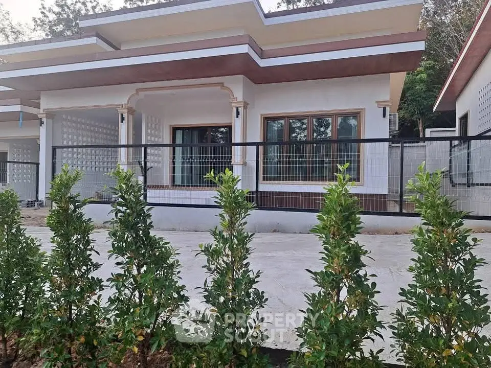 Modern single-story house with sleek design and lush greenery