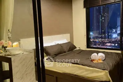 Cozy bedroom with city view, featuring elegant decor and ambient lighting.