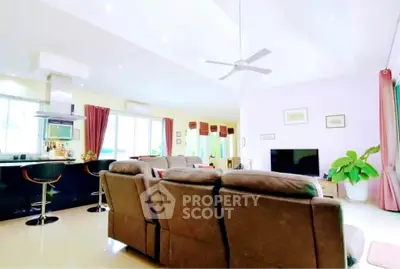 Spacious open-plan living room with modern kitchen and cozy seating area.