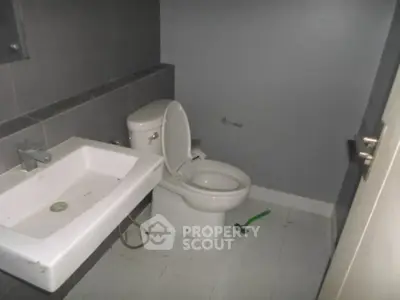 Compact bathroom with modern fixtures and neutral color scheme