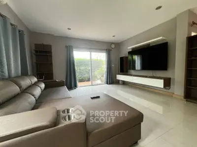 Spacious modern living room with large sectional sofa and wall-mounted TV