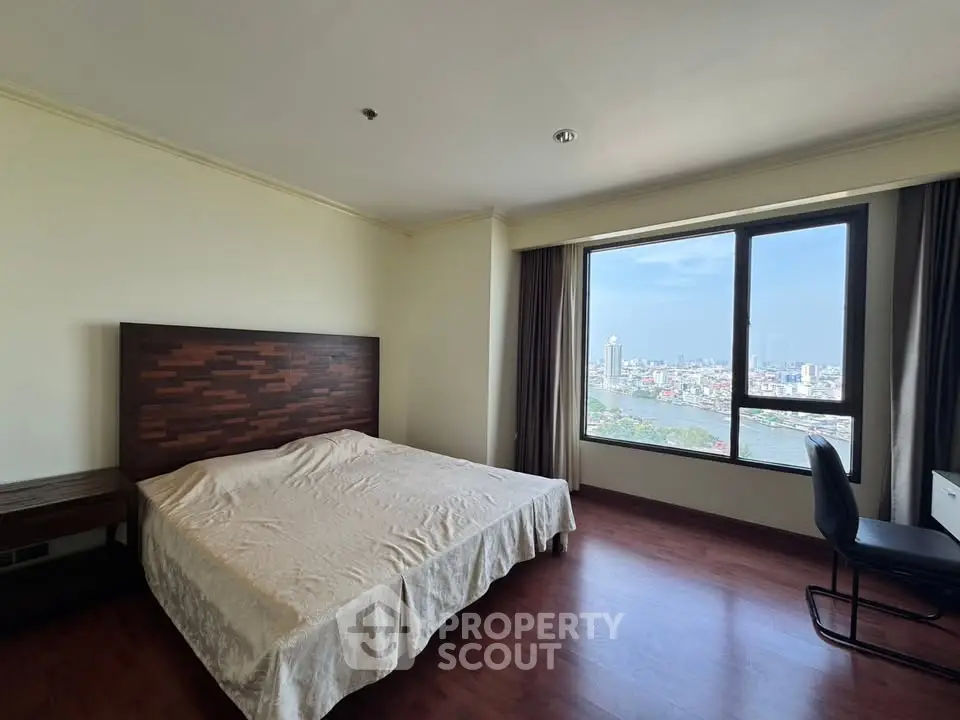 Spacious bedroom with stunning city view and elegant wooden flooring.