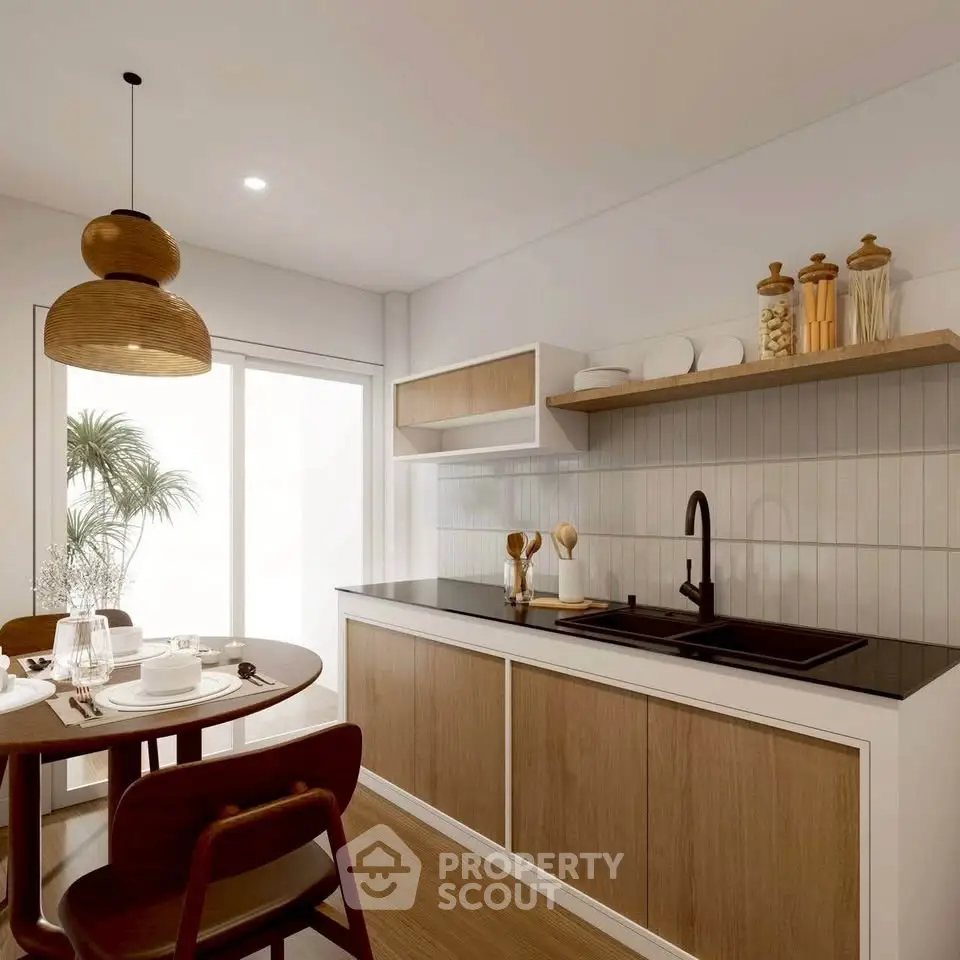 Modern kitchen with sleek design, featuring wooden cabinets, black countertop, and dining area with natural light.