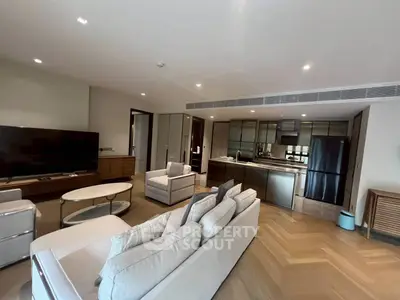 Spacious modern living room with open kitchen and sleek furnishings