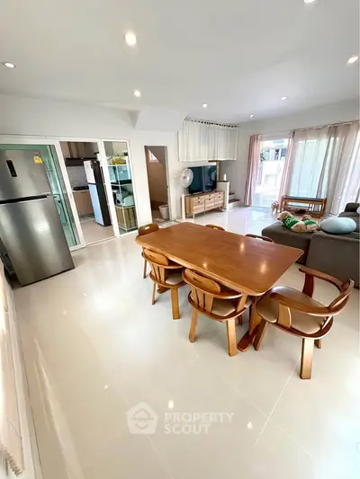 Spacious living room with modern dining area and natural light