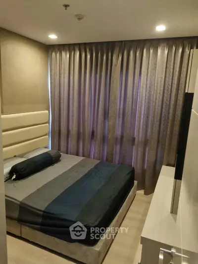 Modern bedroom with stylish decor and cozy ambiance, featuring elegant curtains and contemporary furnishings.