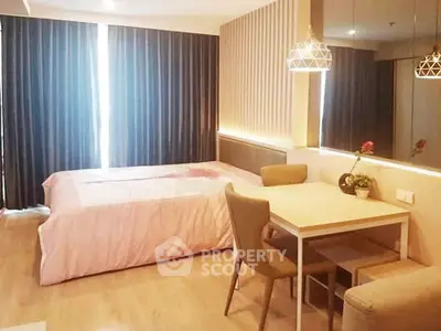 Cozy bedroom with dining area, modern lighting, and elegant decor